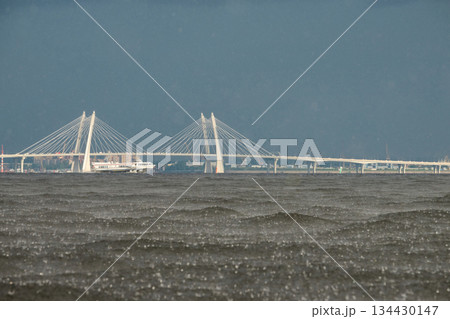 cable-stayed bridge and hydrofoil boat in the background, water surface of the Gulf of Finland in heavily rain, raindrops, storm, Russia, Saint-Petersburg cable-stayed bridge and hydrofoil boat in the background, water surface of the Gulf of Finland in heavily rain, raindrops, storm, Russia, Saint-Petersburg 134430147