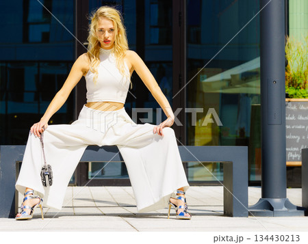 Woman wearing crop top and culottes Woman wearing crop top and culottes 134430213