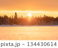 Golden winter sunset in Northern Europe with snowy forest and frozen lake 134430614