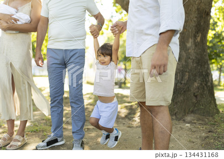 Happy kid playing outdoors supported by loving family 134431168