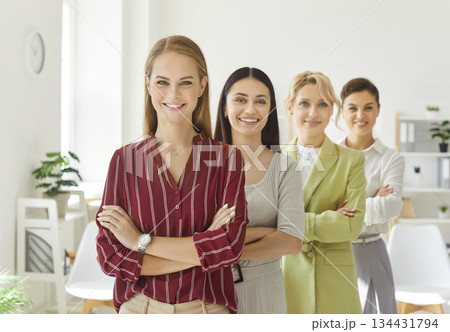 Team of four happy smiling successful beautiful business women in office workplace Team of four happy smiling successful beautiful business women in office workplace 134431794