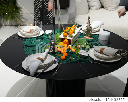 Festive Table With Candles And Mandarins, Cozy Holiday Table With Decorative Ornaments And Warm Lighting Festive Table With Candles And Mandarins, Cozy Holiday Table With Decorative Ornaments And Warm Lighting 134432235