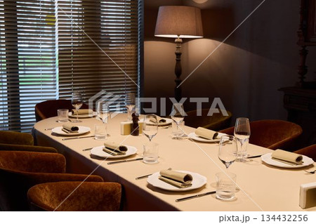 exquisite evening event featuring meticulously arranged tableware and ambient lighting for wine appreciation 134432256