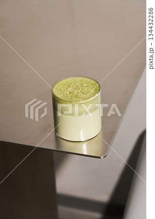 Sophisticated Matcha Beverage Featuring Sleek Metallic Setting And Delicate Froth Detailing Sophisticated Matcha Beverage Featuring Sleek Metallic Setting And Delicate Froth Detailing 134432286