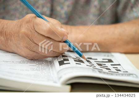 Bangkok, Thailand, March 1, 2023 Asian elderly woman playing puzzle game. Bangkok, Thailand, March 1, 2023 Asian elderly woman playing puzzle game. 134434025