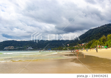Patong Beach Phuket with people promenade turquoise blue water Thailand. 134434261