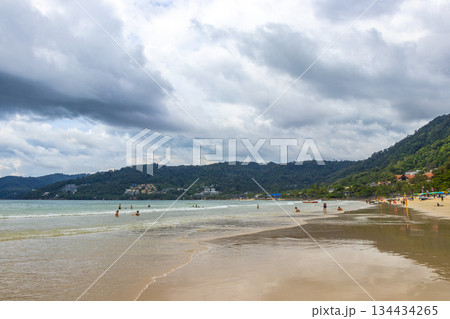 Patong Beach Phuket with people promenade turquoise blue water Thailand. 134434265