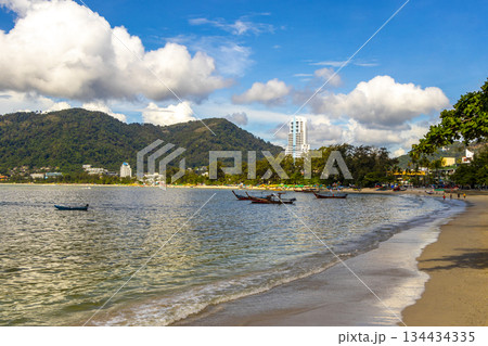 Patong Beach Phuket with promenade boats turquoise blue water Thailand. 134434335