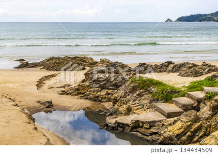 Rocky beach with rocks turquoise water palm trees Patong Thailand. Rocky beach with rocks turquoise water palm trees Patong Thailand. 134434509