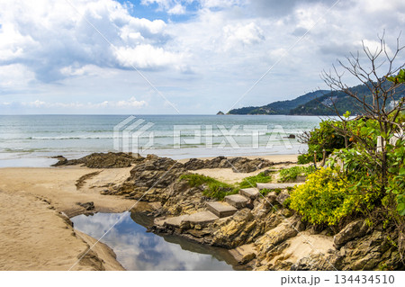 Rocky beach with rocks turquoise water palm trees Patong Thailand. Rocky beach with rocks turquoise water palm trees Patong Thailand. 134434510