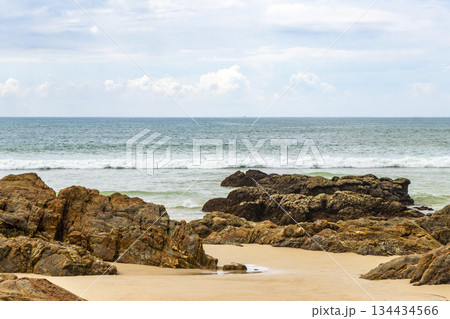 Rocky beach with rocks waves turquoise water in Patong Thailand. Rocky beach with rocks waves turquoise water in Patong Thailand. 134434566