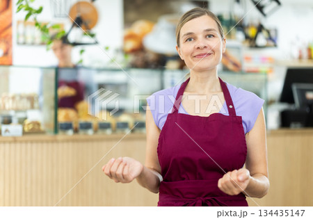 Portrait of friendly female cafe employee 134435147
