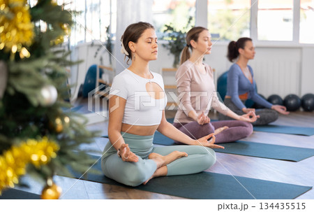 Group of women doing yoga in studio Group of women doing yoga in studio 134435515