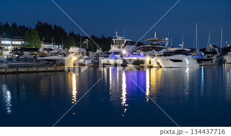 Luxury yacht at night. Night view. Yacht club. Marina in night. Summer vacation. Downtown city marina with luxury illuminated yacht. Docked vessels. Luxury yacht in night marina. Evening yachting 134437716