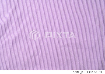 Purple fold knitted fabric background and texture.The fabric features a prominent vertical rib texture. 134438191