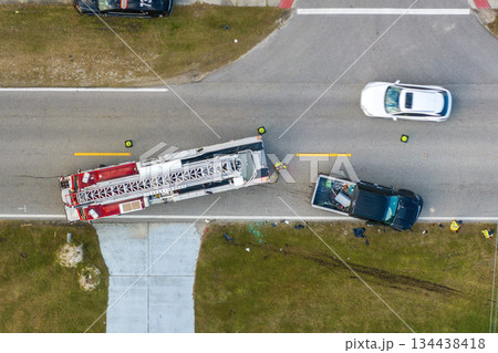 Car crash site with emergency services personnel and vehicles responding to accident on American street. First responders helping victims of vehicle collision on road in USA Car crash site with emergency services personnel and vehicles responding to accident on American street. First responders helping victims of vehicle collision on road in USA 134438418