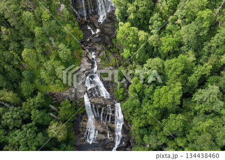 Beautiful landscape of high waterfall with falling down clear water from rocky boulders between green lush woods. Whitewater Falls in Nantahala National Forest, North Carolina, USA 134438460