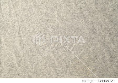 High-resolution.Top view of a light gray heathered fabric, likely a jersey knit used for t-shirts or activewear. High-resolution.Top view of a light gray heathered fabric, likely a jersey knit used for t-shirts or activewear. 134439121