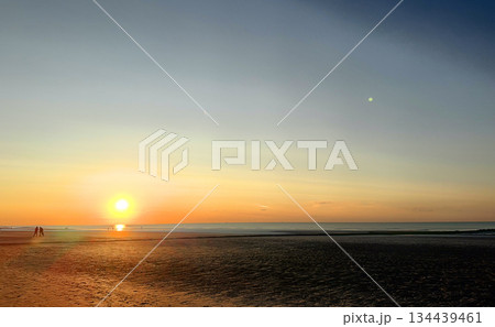 Breathtaking Views of a Stunning Sunset Over a Tranquil Beach Accompanied by Gentle Waves Breathtaking Views of a Stunning Sunset Over a Tranquil Beach Accompanied by Gentle Waves 134439461