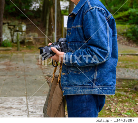神社でカメラを持つシニア男性 134439897
