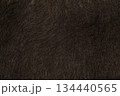 Close-up of dark brown faux fur or thick animal hair, often used for winter garments or home decor. 134440565
