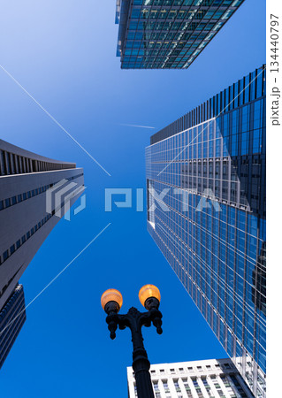 Modern glass building. Skyscraper in city downtown. City downtown with skyscraper. Office building in business district. Skyscraper building architecture. Business skyscraper of glass. Cityscape view 134440797