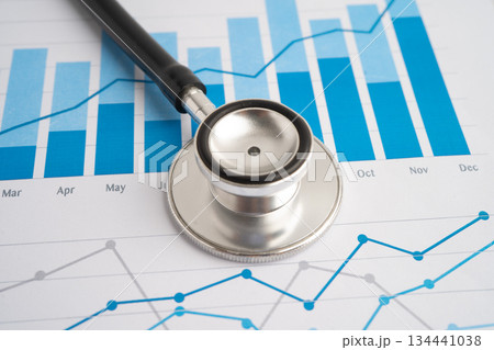Stethoscope on chart or graph paper, Financial, account, statistics and business data medical health. Stethoscope on chart or graph paper, Financial, account, statistics and business data medical health. 134441038