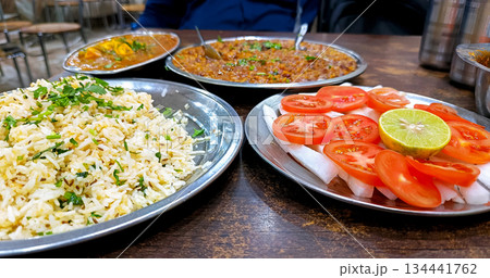 Traditional Indian Dhaba Meal with Rice, Curry, and Salad Traditional Indian Dhaba Meal with Rice, Curry, and Salad 134441762