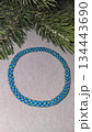 A blue handmade bracelet made of beads and glass beads on a light background. 134443690