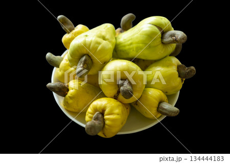 Fresh ripe yellow cashew fruits isolated in black background 134444183