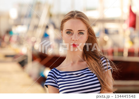 woman in marina against yachts in port woman in marina against yachts in port 134445548