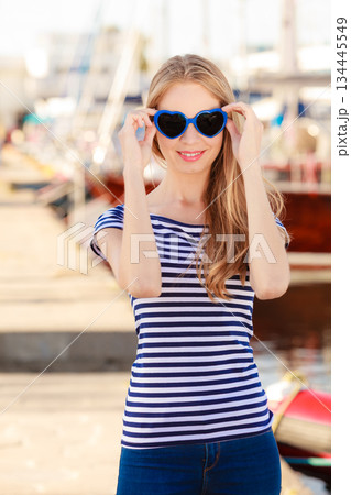 woman in marina against yachts in port woman in marina against yachts in port 134445549