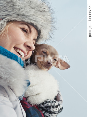 Woman hug warming her dog in cold day 134445771