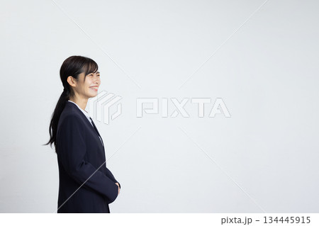 白い壁の前で微笑む若いビジネスウーマンの横顔 134445915