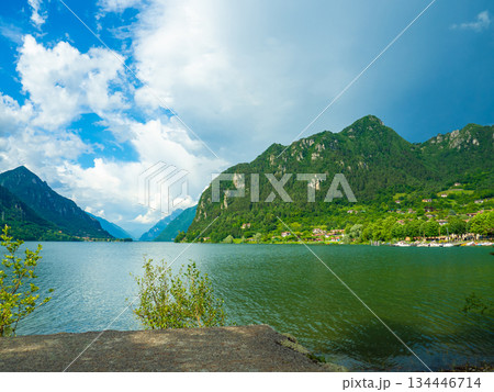 Serene Lake Idro Surrounded by Majestic Mountains and Cloudy sky, Italy, Crone Serene Lake Idro Surrounded by Majestic Mountains and Cloudy sky, Italy, Crone 134446714