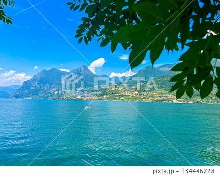 View of Iseo Lake Surrounded by Majestic Mountains and Clear Blue Skies, Italy 134446728