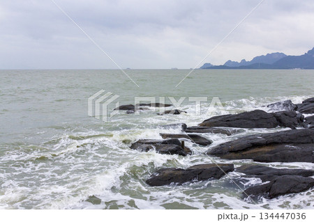 Landscape of sea wave and rock on the shore in the cloudy day, Thailand. Landscape of sea wave and rock on the shore in the cloudy day, Thailand. 134447036