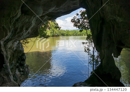 View of the river through the cave on the background of blue sky, Thailand View of the river through the cave on the background of blue sky, Thailand 134447120