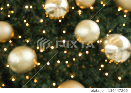 Festive Christmas Bokeh Background with Golden Ornaments and Sparkling Lights. 134447206