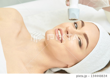 Caucasian female receiving facial treatment at spa with advanced beauty Caucasian female receiving facial treatment at spa with advanced beauty 134448634