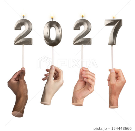 Close-up of hands holding bright 2027 candles symbolizing festive New Year atmosphere, celebration 134448660