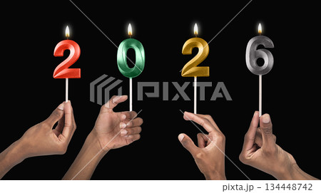 Human hands holding shiny 2026 candles as a symbol of coming New Year celebration and joyful 134448742