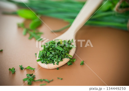 Natural seasonings from greens and onions on brown background 134449250