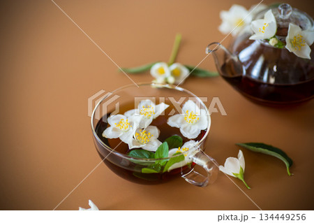 Fragrant jasmine tea in a glassware on a brown background 134449256