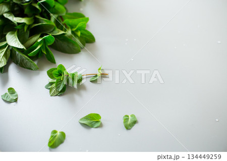Bunch of fresh aromatic mint on gray textured background Bunch of fresh aromatic mint on gray textured background 134449259
