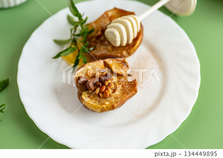 A cozy homemade dessert of baked apples with golden honey 134449895