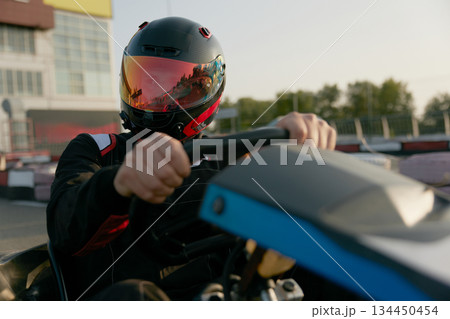 Portrait of a passionate racer skillfully drives a gokart 134450454