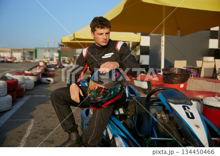 A young and enthusiastic kart racer gets ready to compete at the GoKart racing track 134450466