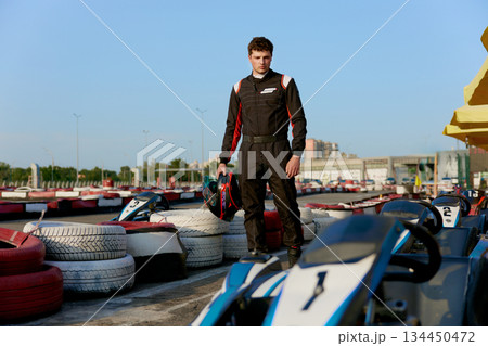 Young race car driver preparing for karting competition 134450472