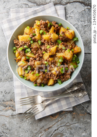 Ground Beef and Potato Stir-Fry closeup on the plate. Vertical top view 134450670